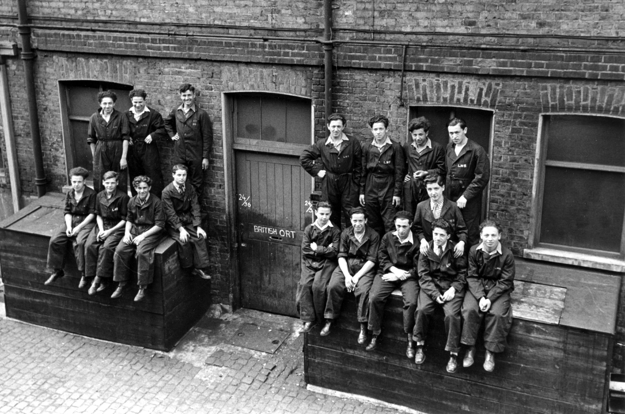 Photograph of Boys at the ORT School, London. Backrow right Weinstock unknown two Chaim Kohn front row right extreme left Salek Orenstein front row right extreme right Jack Melzer.