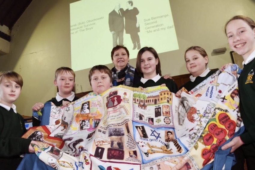 Photograph of Sue Bermange at school presentation with Memory Quilt.