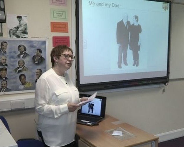Photograph of Sue Bermange giving school presentation on her father, Bob Obuchowski